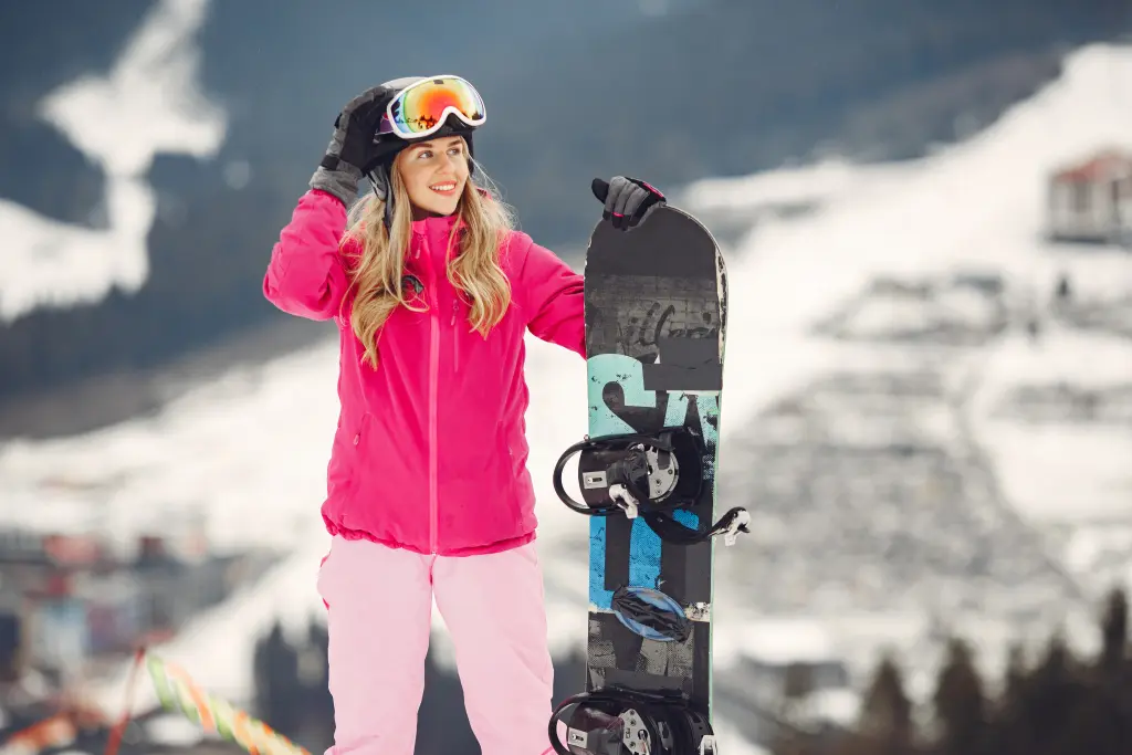 woman-in-snowboard-suit-sportswoman-on-a-mountain-with-a-snowboard-in-the-hands-on-the-horizon-concept-on-sports.jpg