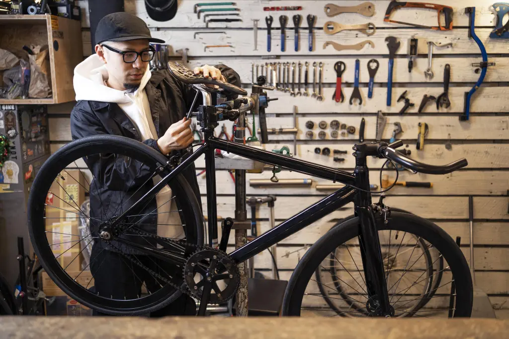 medium-shot-man-repairing-bike-in-store.jpg